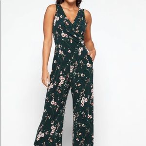 Dark green jumpsuit with pink flowers. Includes pockets and stretchy.